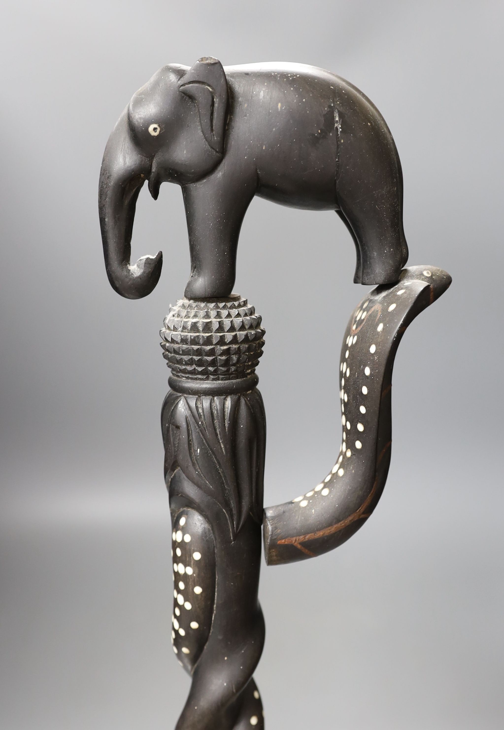 A late 19th/early 20th century Ceylonese carved ebony ‘elephant’ walking stick, 90cm